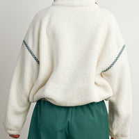 Back view of cream oversized sherpa fleece pullover with green gingham shoulder seam detailing