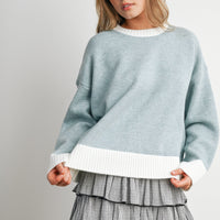 Blue and Ivory relaxed knit sweater with contrast hem, front detail