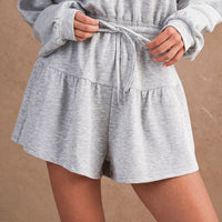 Bottom view of women's heather gray hooded romper with gathered waist