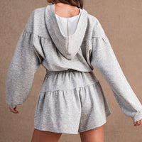 Back view of women's heather gray hooded romper with gathered waist