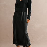 Black satin maxi dress with matching black V-neck knit sweater set