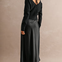 Back view of V-neck knit sweater with feminine tie-back detail
