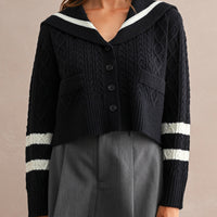 Women's navy sailor collar cable knit cardigan with button front and contrast ivory sleeve stripes