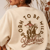 Close-up of the Born To Be Wild cowboy and horseback back graphic on the AFTERGLOW sweatshirt
