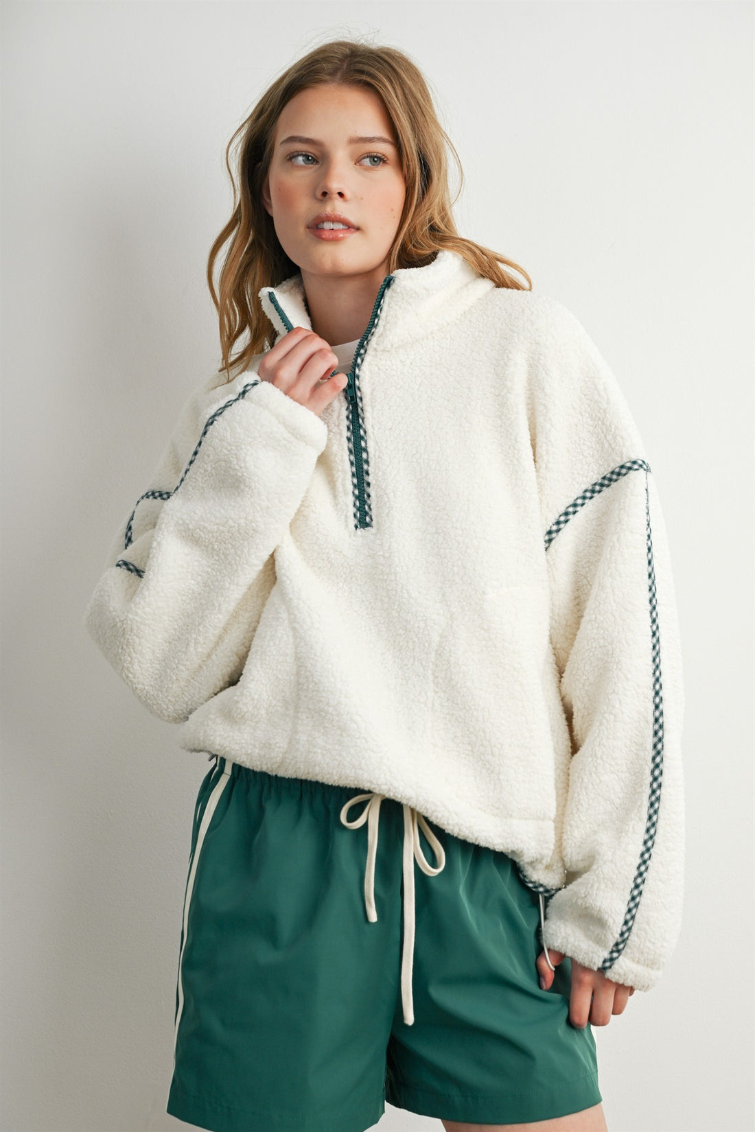 Women's oversized cream sherpa fleece half zip pullover with green gingham trim and stand collar