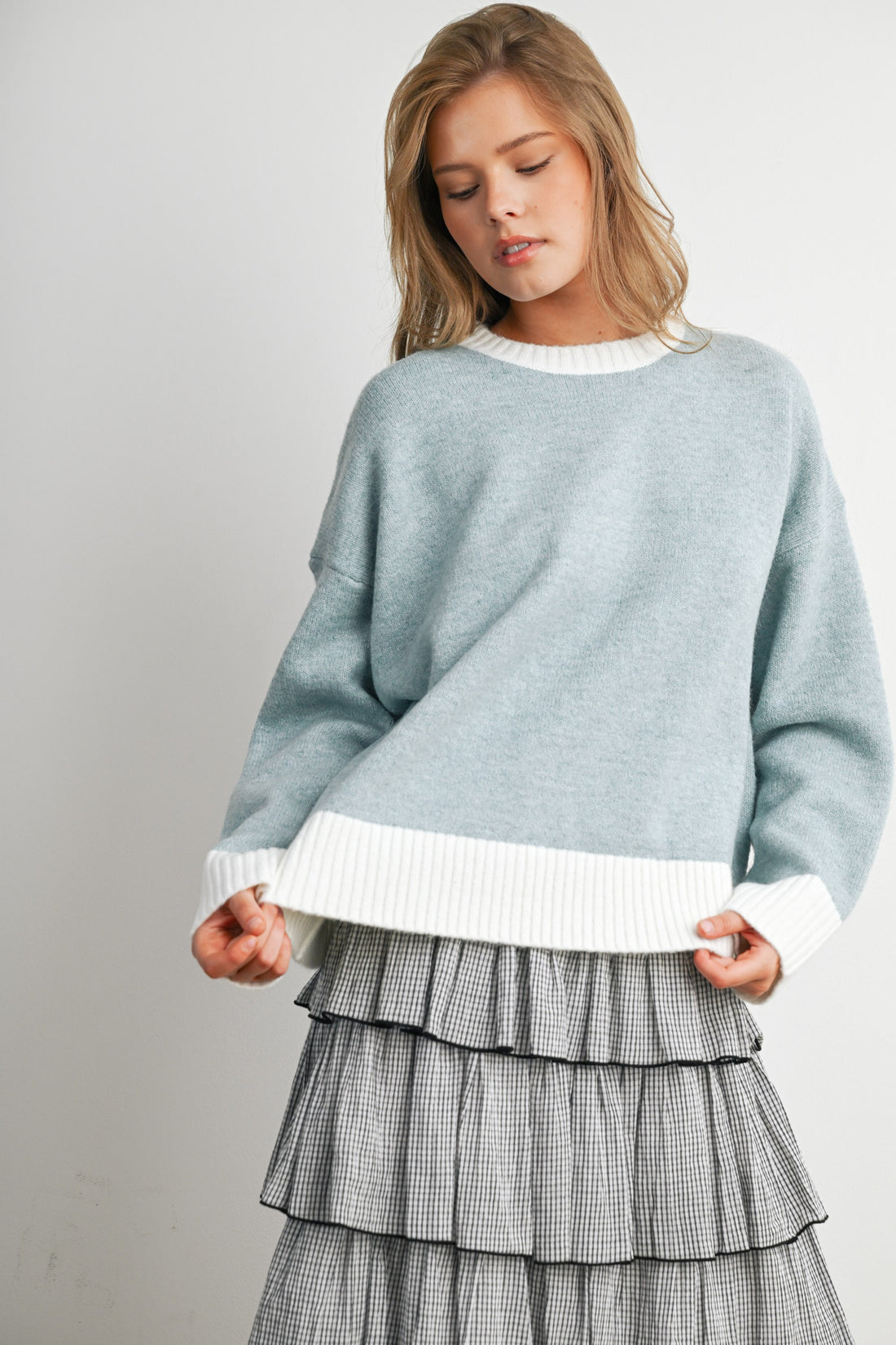 Blue and Ivory relaxed knit sweater with contrast hem, front detail