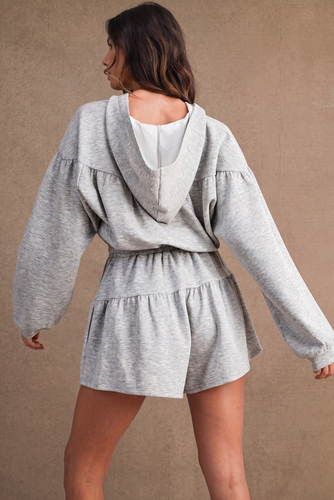 Back view of women's heather gray hooded romper with gathered waist