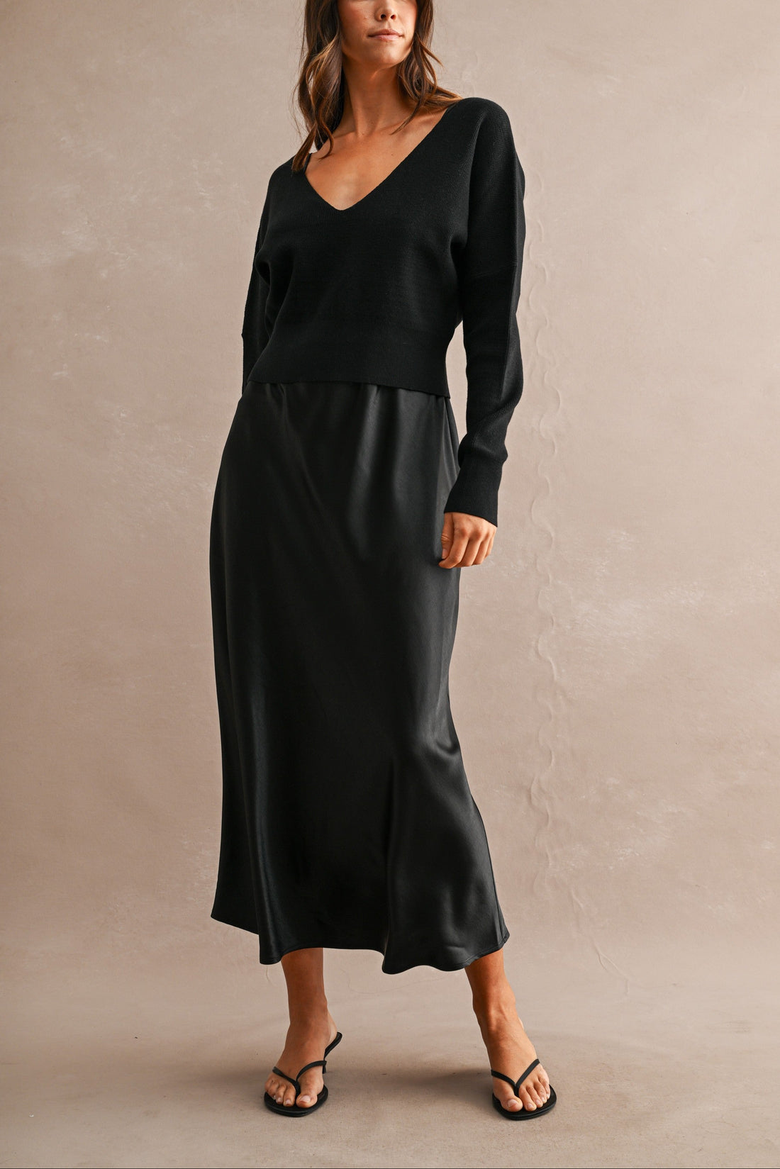 Black satin maxi dress with matching black V-neck knit sweater set