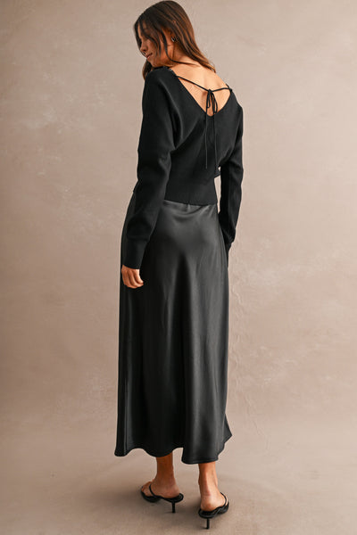 Back view of V-neck knit sweater with feminine tie-back detail