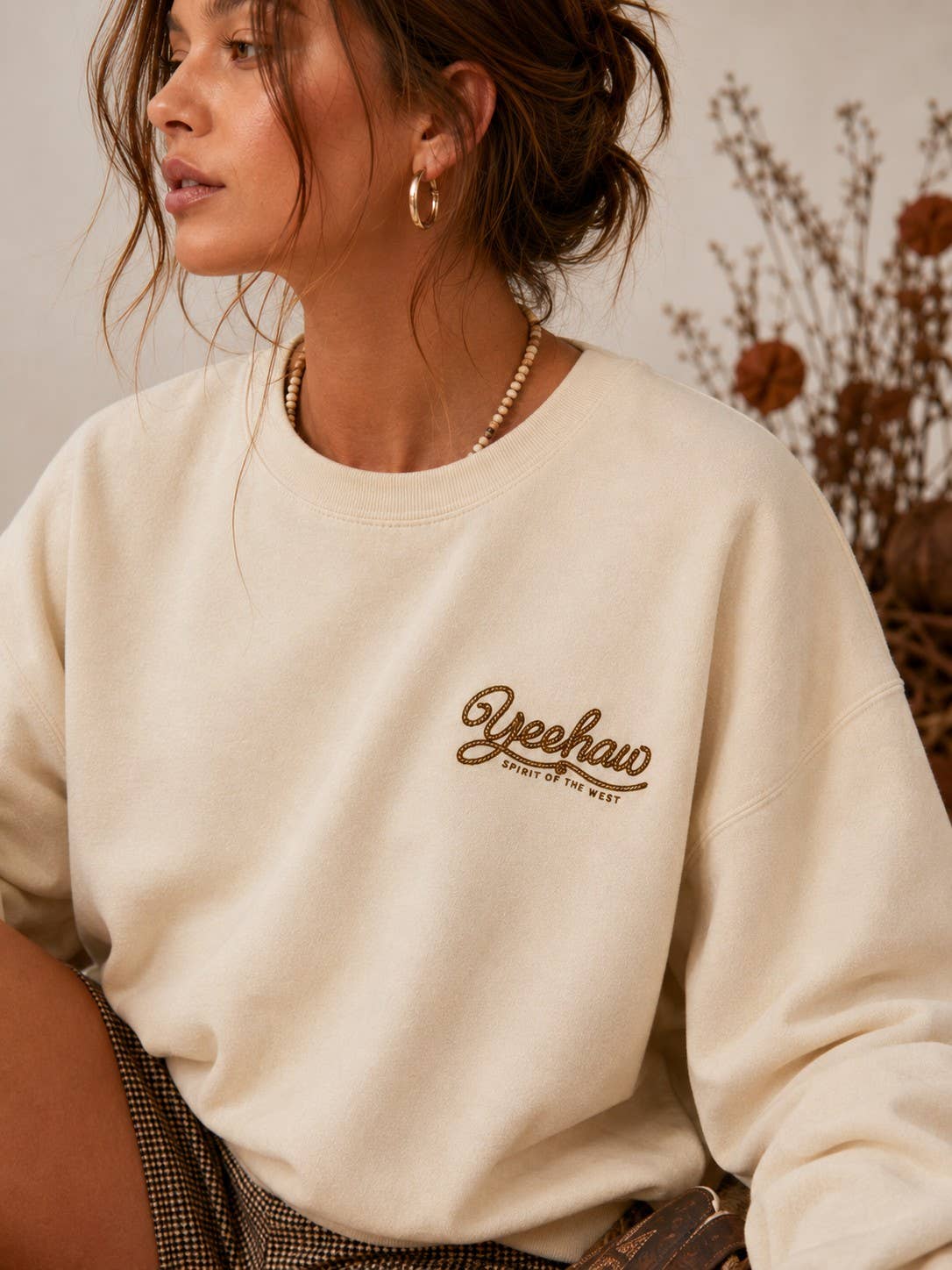 Front view of the AFTERGLOW western sweatshirt on a model with the small Yeehaw Spirit of the West graphic